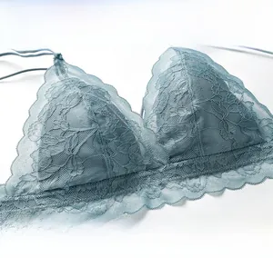 Detailed close-up of floral eyelash lace fabric on a wireless bralette in dusty blue