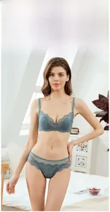 Detail view of the fine lace texture and floral patterns on this grey-blue lingerie set