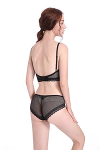Detail view of black lace lingerie set featuring sheer mesh fabric and deep U-back design