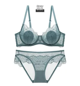 Gray blue sheer lace lingerie set with floral patterns and scalloped edges flat lay view