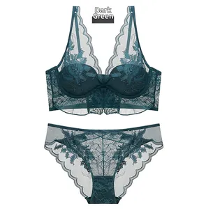 Detail of dark green lace lingerie set with floral embroidery and scalloped edges