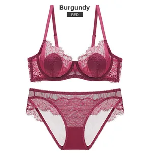 Detailed close-up of wine red lace lingerie set with sheer floral embroidery and scalloped edges