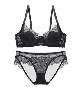Lace lingerie set with eyelash lace bra and matching panties in black on white background