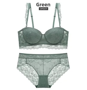 Detailed view of dark green lace lingerie set featuring floral cups and scalloped edges