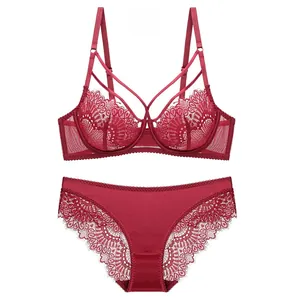 Detail of red lace lingerie set featuring sheer floral embroidery and scalloped edges
