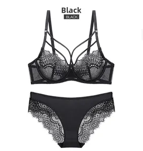 Detail of black lace lingerie set with cross-straps and scalloped lace panties on white back