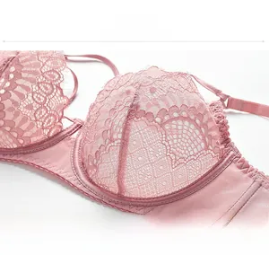 Detailed view of pink floral lace bra with delicate eyelash trim and sheer mesh texture