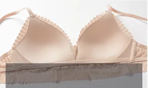 Detailed macro view of breathable cotton inner cup and delicate lace trim on nude bra