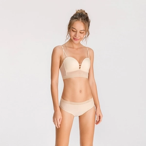 Detail of beige U-back bra with adjustable straps and delicate scalloped lace edges