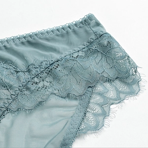 Greyish blue French lace panties with sheer eyelash lace and mesh details in a flat lay view
