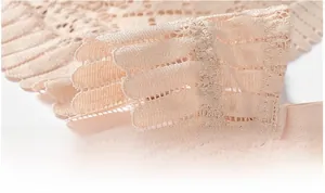 Close-up of nude lace side wings with breathable hollow patterns and adjustable strap