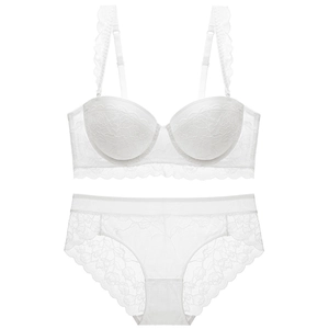Elegant white lace lingerie set with floral patterns and ruffled shoulder straps on white background