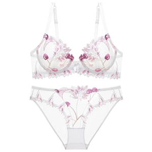 Detail view of white mesh lingerie set with purple floral embroidery and lace texture