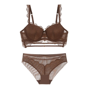 Flat lay of brown eyelash lace lingerie set with mesh details and scalloped floral edges