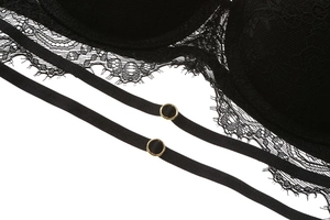 Close-up of black eyelash lace lingerie with double straps and golden metal rings