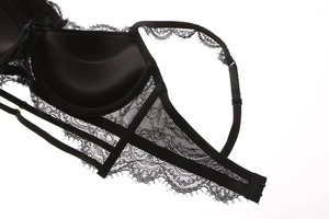 Close-up of black eyelash lace bra featuring intricate floral patterns and adjustable straps