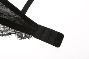 Close-up of black floral lace bra back showing three-row hook and eye closure details