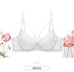 Detail of white lace bra featuring delicate floral embroidery and adjustable straps