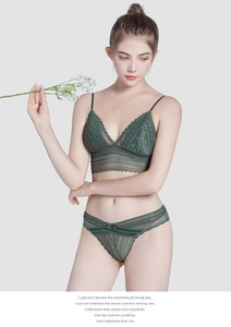 Detail view of emerald green lace lingerie set with floral patterns and triangle cups