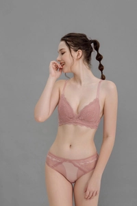 Close-up of elegant rose pink floral lace bra and mesh panty set on a female model
