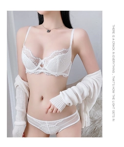 Detailed view of white floral lace lingerie set with matching knit cardigan on model