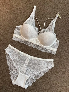 Close-up of white floral lace lingerie set with underwire bra and matching panties