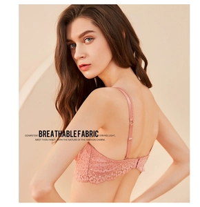 Close-up of pink floral lace fabric and delicate straps on a breathable French bra