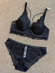 Detail of black lace lingerie set with floral embroidery and delicate scalloped edges