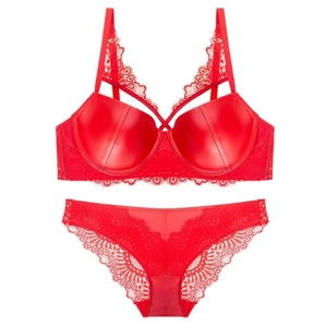 Red lace lingerie set with underwire bra and strappy details on white background