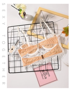 Exquisite white floral lace detail on semi-sheer nude mesh cup with golden hardware