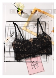 Detail view of black lace bralette featuring delicate floral patterns and front button closure