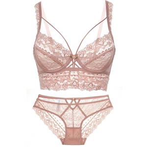 Detailed close-up of lace bra set with floral embroidery and rose flower accents