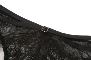 Macro view of delicate black floral lace and adjustable silver metal strap buckle