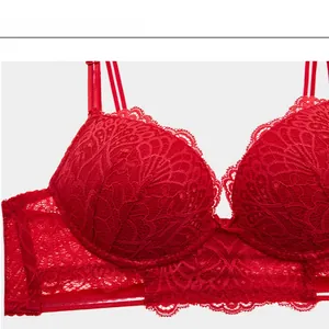 Detailed close-up of red lace bra featuring intricate floral patterns and scalloped edges