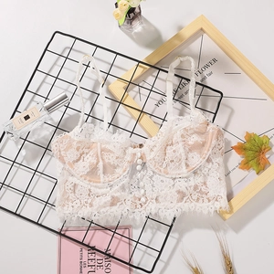 Elegant white lace bralette with eyelash trim and decorative buttons on mesh background