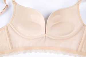 Detail of beige push-up bra featuring breathable mesh wings and delicate lace trim