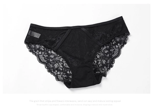 Detail of elegant black floral lace panties with semi-transparent mesh and elastic waistband