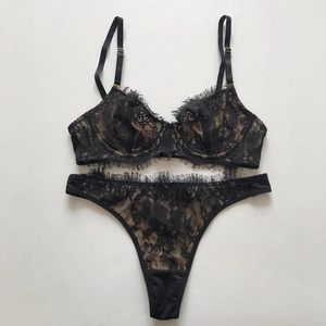Flat lay of delicate black eyelash lace lingerie set featuring sheer mesh and adjustable straps