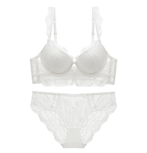 Flat lay of white floral lace lingerie set featuring an elegant bra and matching panties