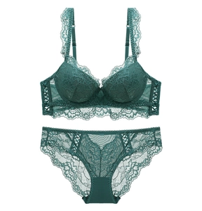 Flat lay of dark green lace lingerie set with push-up bra and matching panties