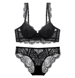 Flat lay of black floral lace lingerie set with push-up bra and cutout lace panties
