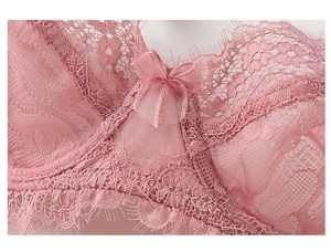 Close-up of pink eyelash lace bra with floral patterns and a small bow detail