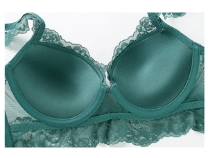 Detailed macro of forest green lace bra with eyelash trimming and silk cup lining