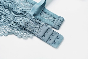 Close-up of Morandi blue lace bra featuring three-row hook-and-eye back closure details