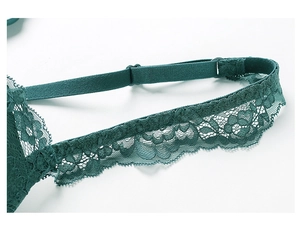 Detail of dark green floral lace bra with adjustable straps and wavy scallop edges
