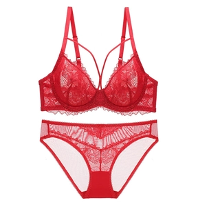 Detailed flat lay of red lace bra and matching panties with delicate floral patterns