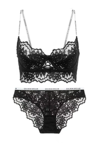 Detail of black lace bra set with lettered straps and front criss-cross drawstring decoration