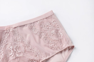 Detailed close-up of pink lace panties featuring floral embroidery and a small bow tie
