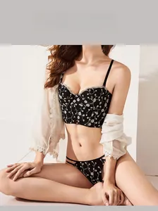 Detail of black floral embroidery and white lace trim on a French-style lingerie set