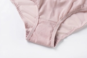 Detail of breathable mesh fabric and reinforced cotton crotch stitching on lace panties